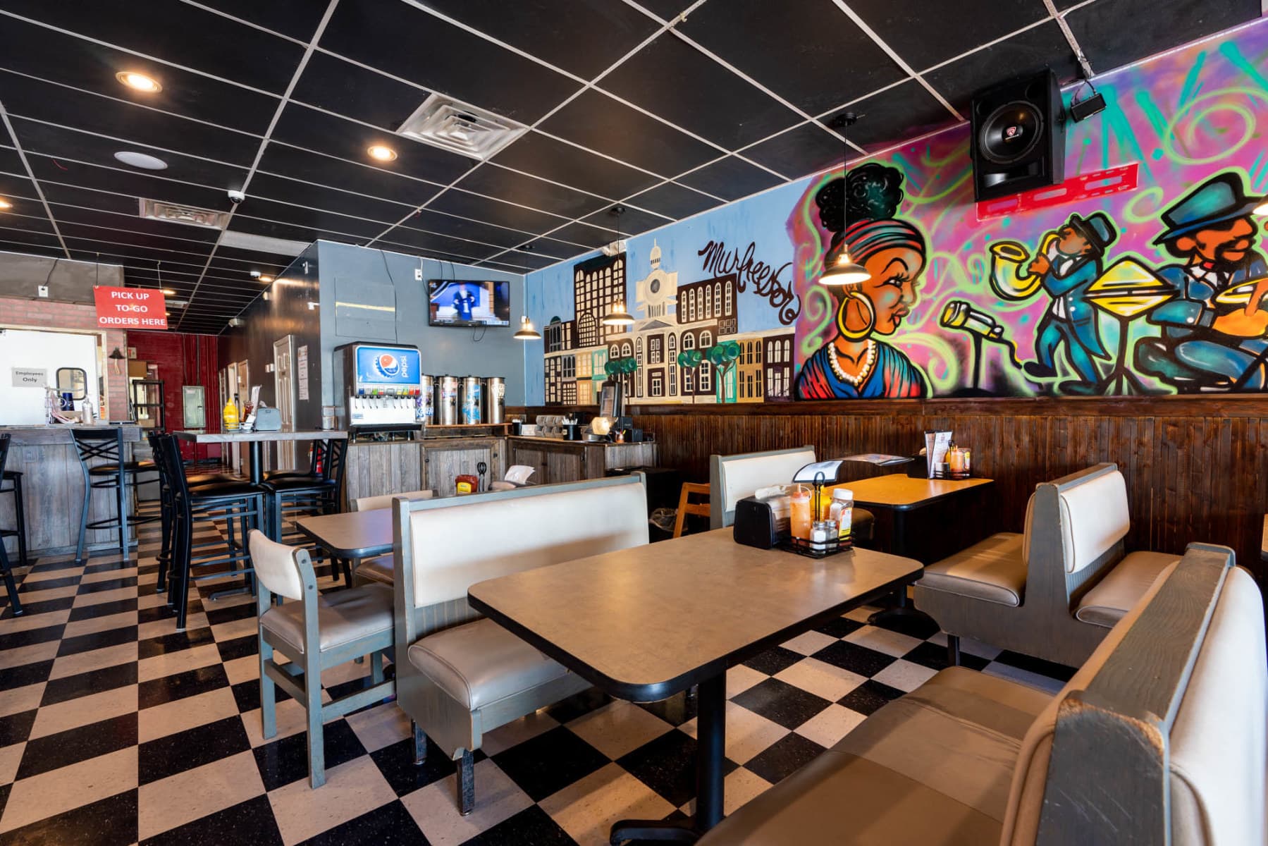 Dining room with booths, checkerboard floor and Murfreesboro mural