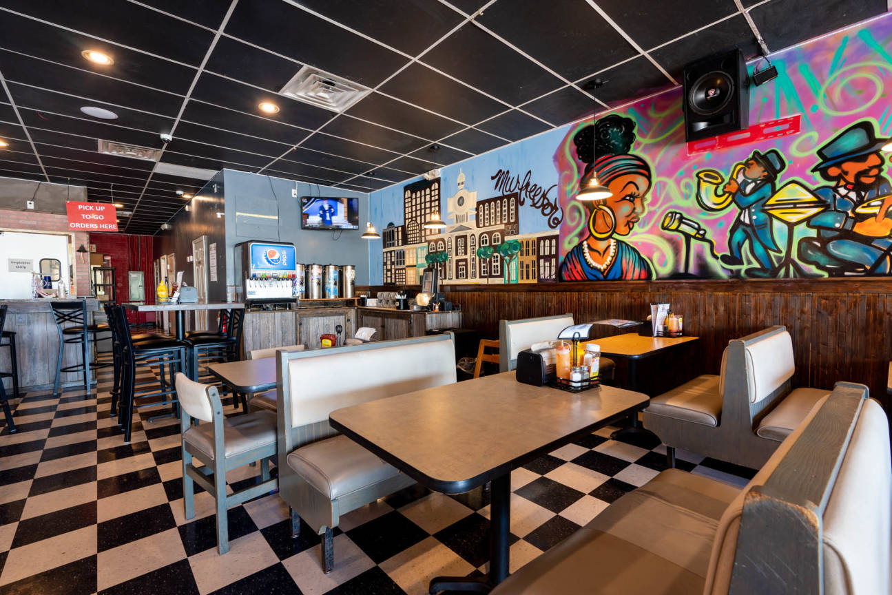 JoJos Fish House dining room with booths and Murfreesboro mural